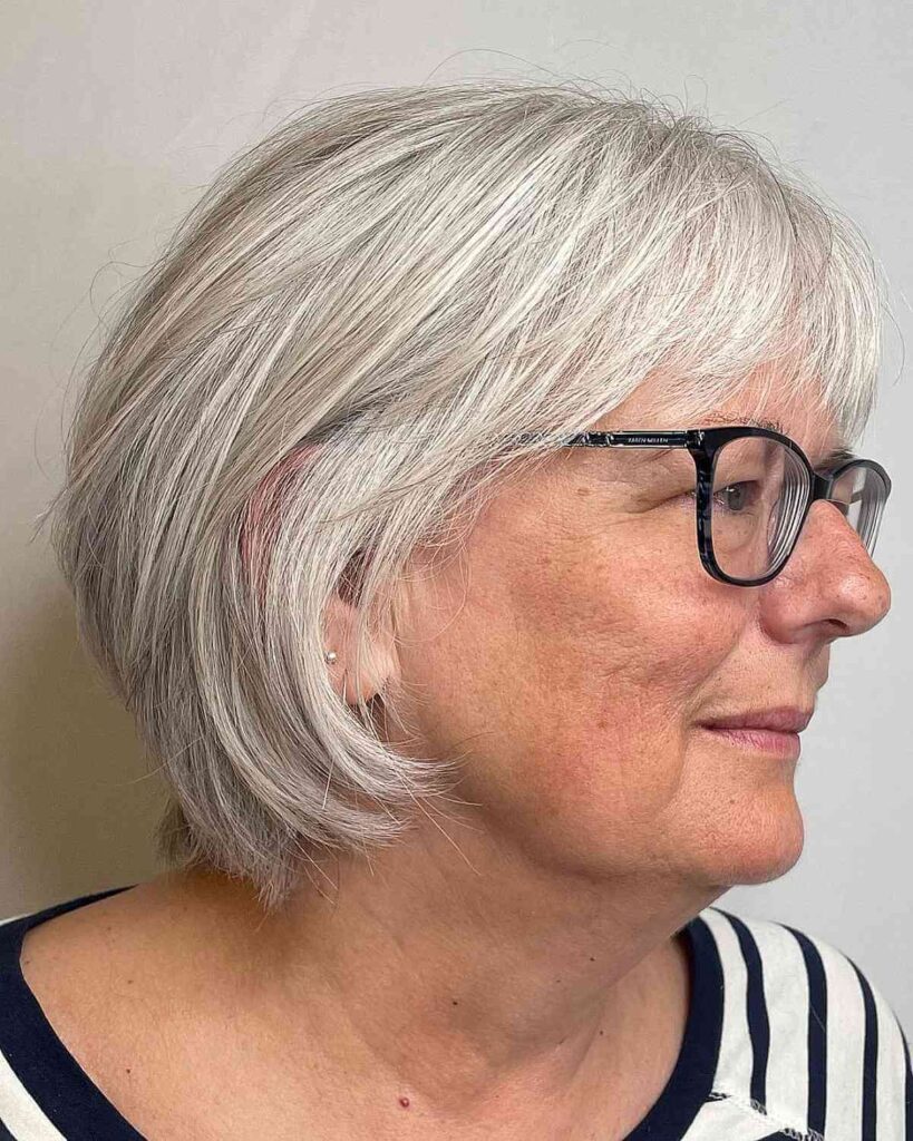 feathered bob with bangs for women over 60 with glasses