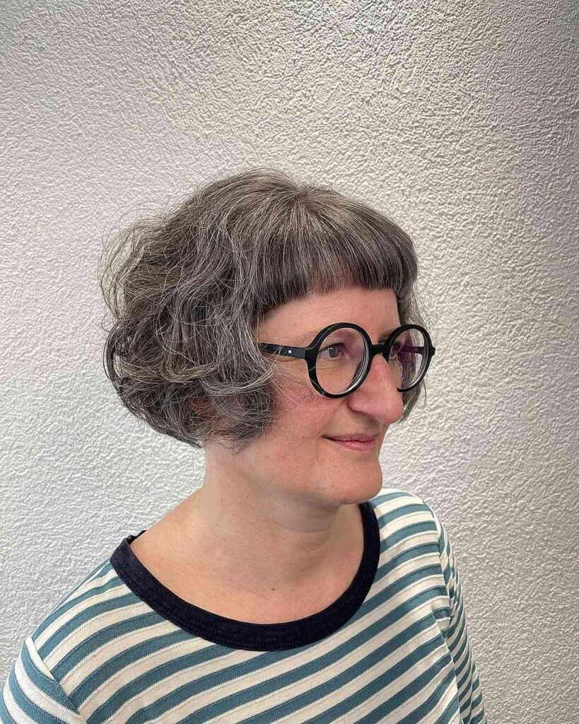 tousled ear length cut with short bangs for 60 year old women
