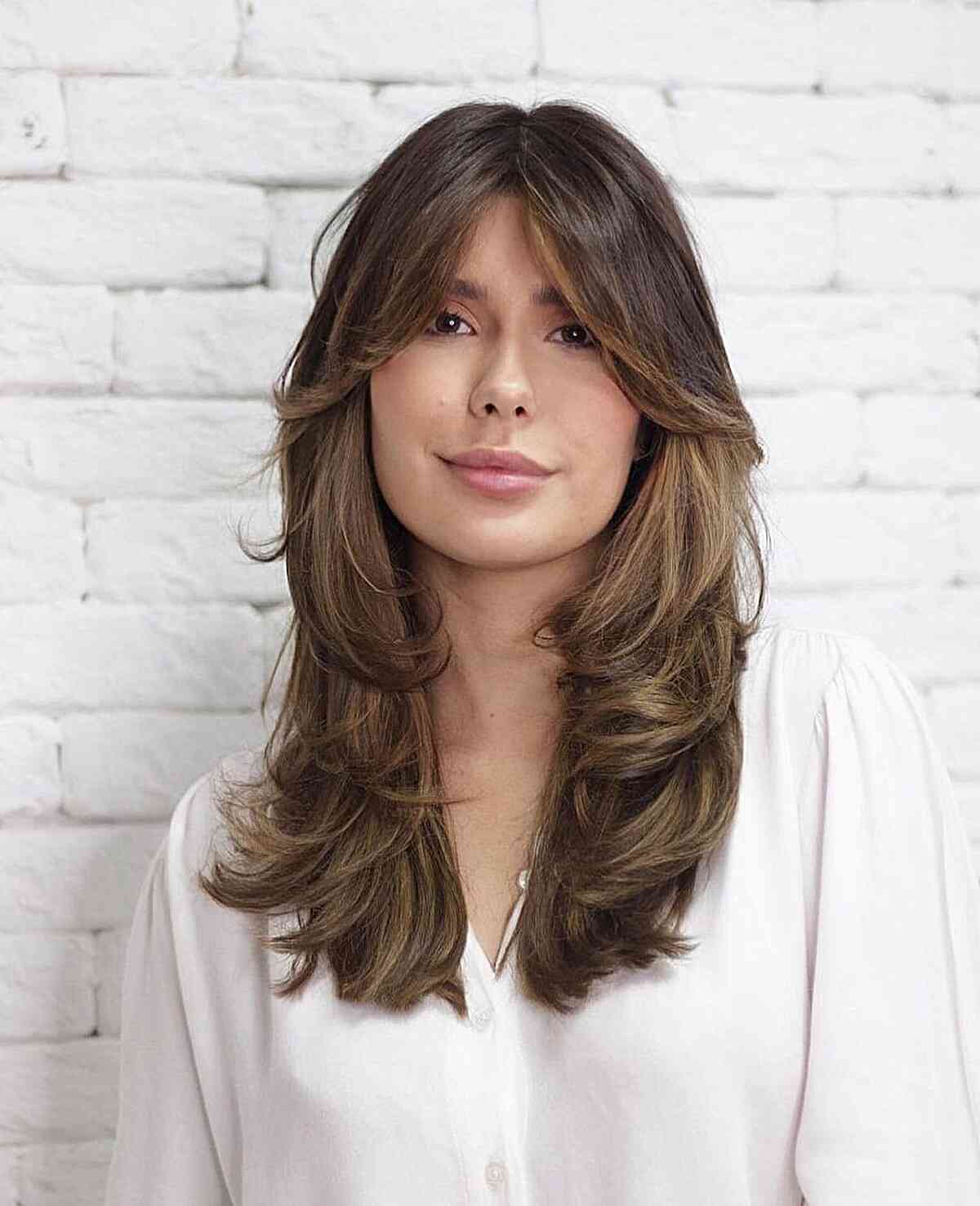butterfly cut wavy hair with face framing bangs